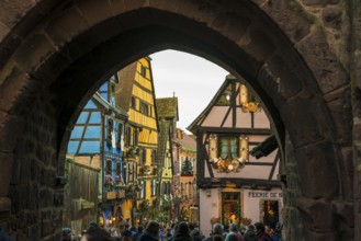 Christmassy decorated half-timbered houses, Christmas market, Riquewihr, Grand Est, Haut-Rhin,