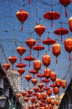 From below a captivating display of vibrant red lanterns adorned with Chinese characters, suspended