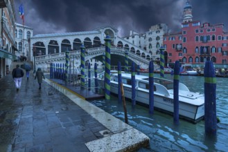 Rain clouds over the Rialto Bridge, a police boat anchored in front, Venice, Veneto, Italy