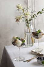 Elegant glass present a sophisticated serving of vanilla and chocolate ice cream, garnished with