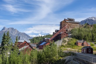 Red Kennicott buildings in front of mountainous landscape, Kennicott Concentration Mill to extract