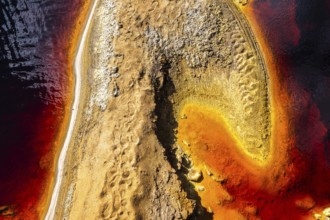 Aerial view of the vibrant red and orange hues along the banks of the Riotinto in Huelva, Spain,