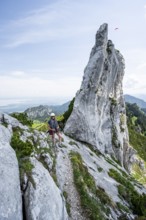 Climber with climbing rope on a climbing tour, climber on a mountain ridge, pointed rock peak,