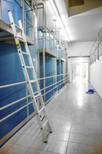 Long corridor with blue walls and a ladder on the side, ENCW Netze Calw waterworks, Calw, Black