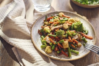 Plate of stir-fried mixed vegetables with green beans, carrots, baby corn, romanesco and mushrooms