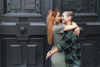 A Colombian lesbian couple lovingly embraces, symbolizing unity and diversity. Their affectionate