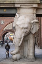 Bicyclist, monumental stone elephant, Elephant Gate or Elephant Portal or Elefantporten, by