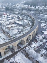Snowy town with a bridge and cars in a winter landscape seen from the air, Nagold, Black Forest,