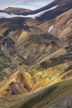 Small river between colourful rhyolite mountains, volcanic landscape, colourful erosion landscape,