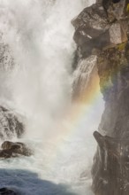 Fossardalur Waterfall with rainbow, close to Djupivogur at the Berufjord, Easter Iceland