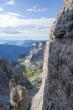 Climbers on a rock band, Bocchette Centrale band trail, via ferrata in the Brenta Mountains,