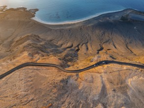 Road on cliffs in evening light, steep cliffs on the coast near Mirador del Porrito, aerial view,