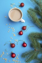Christmas or New Year composition. Decorations, red balls, fir and spruce branches, cup of coffee,