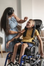A mother lovingly cares for her son, who has cerebral palsy, sitting in a wheelchair. The scene