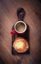 Pastries, breakfast, a bun with cottage cheese and a cup of coffee, top view, no people