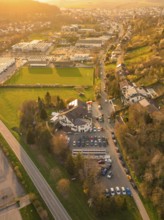 Aerial view of a road through a rural and urban environment at sunset, Europäischer Hof,