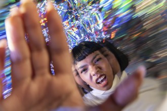 A futuristic Latin woman engages with the vibrant and dynamic digital world of the metaverse,