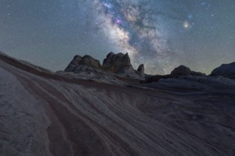 Vivid Milky Way illuminates the striped rock formations in the Utah desert under a starry sky