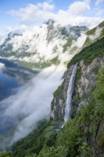 Gjerdefossen waterfall, at Ørnesvingen viewpoint, atmospheric clouds over the fjord in the morning