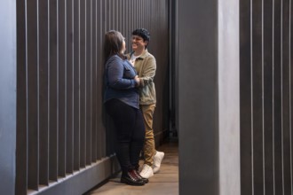 A lesbian couple shares a tender moment in an urban setting, expressing love and connection. The