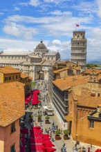 Above the rooftops of Pisa, behind the Cathedral of Santa Maria Assunta and the Leaning Tower, Via