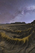 Stunning capture of the Milky Way illuminating the textured sandstone desert landscape in Utah,