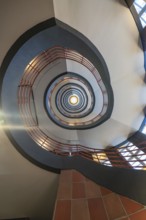 Dizzying view through a spiral staircase with red and black elements, SPRINKENHOF, Hamburg, Germany