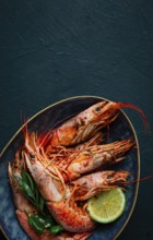 Langoustines, Australian, freshly frozen on ice, top view, lime and greens