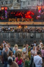 Spectators on grandstand at the Graslei watching Pole Pole podium during Gentse Feesten, Ghent city