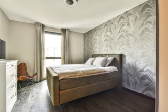 A stylish and contemporary bedroom featuring a cozy bed, elegant decor, and large windows that