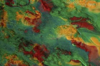 Vibrant swirls of metallic green and red paint create a textured abstract art background