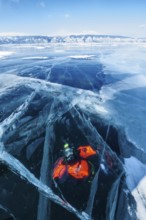 Scuba diver under ice, Lake Baikal, Pribaikalsky National Park, Irkutsk Province, Siberia, Russia