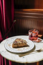 A delectable waffle cake layered with creamy truffle condensed milk, topped with chocolate drizzle,