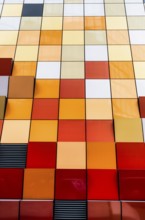Close-up view of a vibrant and multi-colored tiled facade of a building in Hong Kong. The image