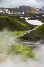 Colourful volcanic landscape with hills and snow, volcanic steaming hot springs, Laugavegur