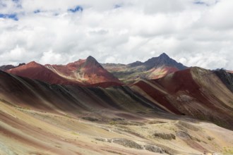 A remarkable landscape of Vinicunca, known as the Rainbow Mountain, featuring striking naturally