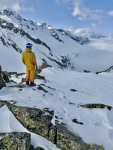 Skier enjoying the view of a valley with clouds, mountain scenery in winter, Fellilucke, Glarner