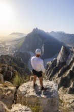 A man stands on a rocky peak at Eagle's Nest in Monterrey, Mexico, taking in the breathtaking view