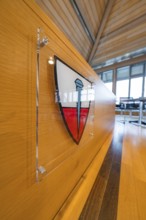 Modern interior decoration with coat of arms on a wooden wall panelling, Nagold Town Hall, Black