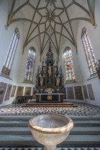 High altar in the late Gothic church of St Martin, baptismal font in front, first construction