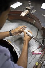 Gemstone cutter cutting a sapphire ring, gemstone cutting workshop in Kandy, Central Province, Sri