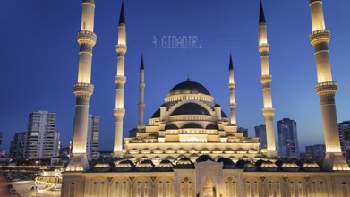 Aerial view captures hundreds of Muslims gathered at long tables for a communal Iftar meal in a