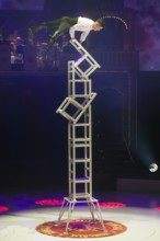 Artist on chairs at the Roncalli Christmas Circus in Berlin's Tempodrom on 20 December 2024