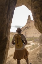Vertical photo of the rear view of an explorer in the desert