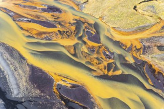 Stunning aerial capture of Iceland's golden rivers winding through vibrant landscapes, showcasing a