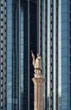 A striking display of architectural contrast in Colon City, Panama, showing a historic statue