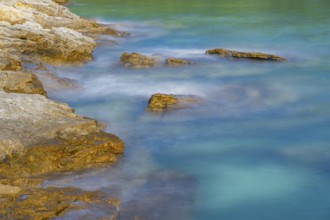 Crystal clear and turquoise water on the beach of Ustrine Bay on a sunny day on the island of Cres,
