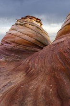 Dramatic sandstone formations with sweeping curves and layered colors captured at Coyote Buttes in