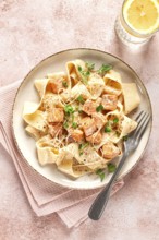 Tagliatelli pasta, with salmon slices and herbs, on a decorative plate, homemade, no people