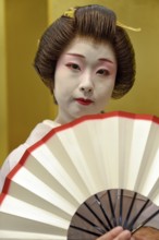 Geisha in traditional costume, portrait, fan, omori, Tokyo, Japan